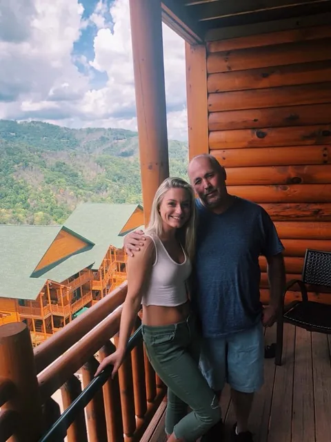 Roger and his daughter on a cabin balcony